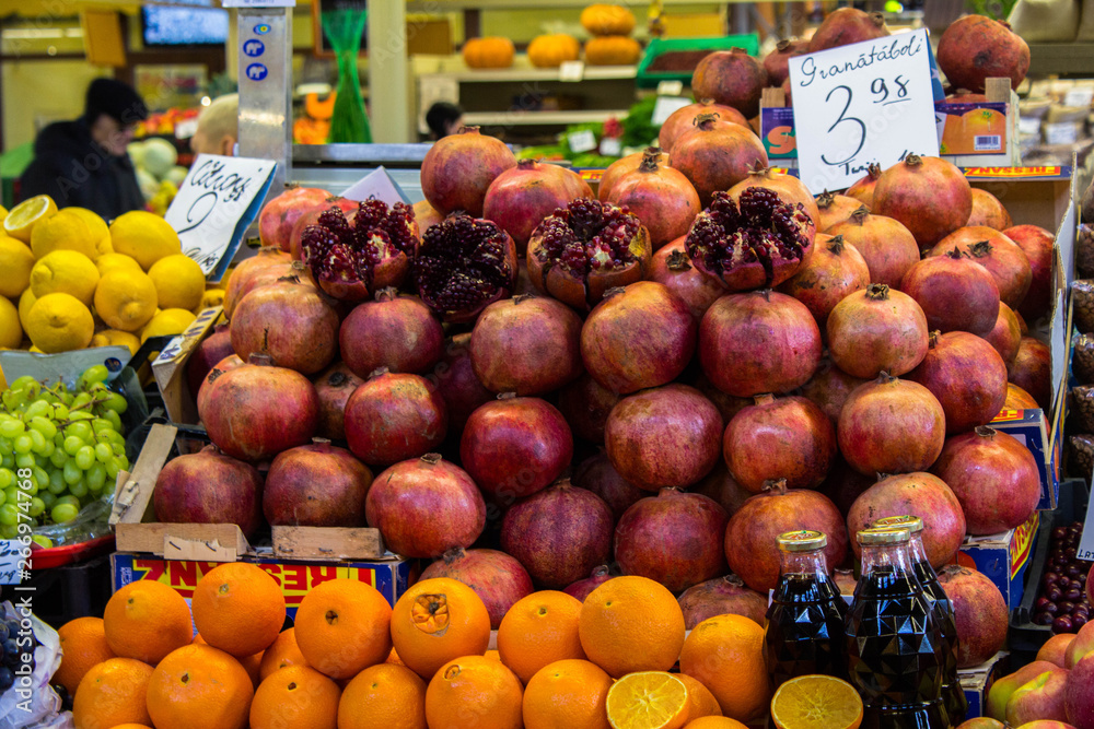 Pomegranate, oranges and lemons on the famous market of Riga, Latvia. Colorful fresh fruits on the market. Healthy food.