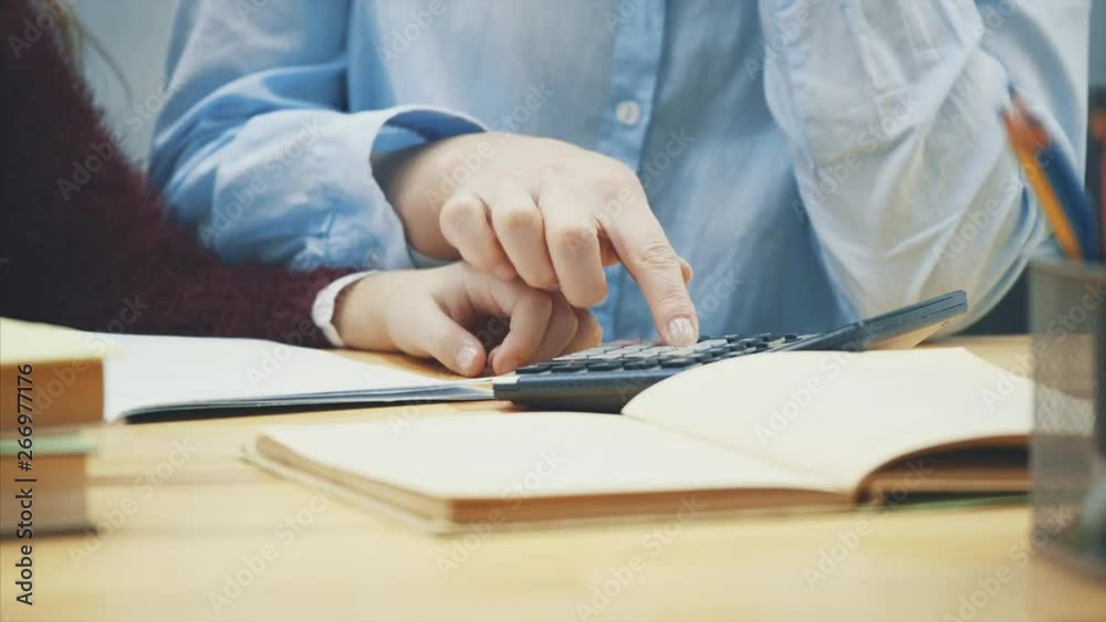 Close-up of mother and daughter's arms on a gray background on the table. r. Close-up of mother and daughter's arms on a gray background on the table. r.