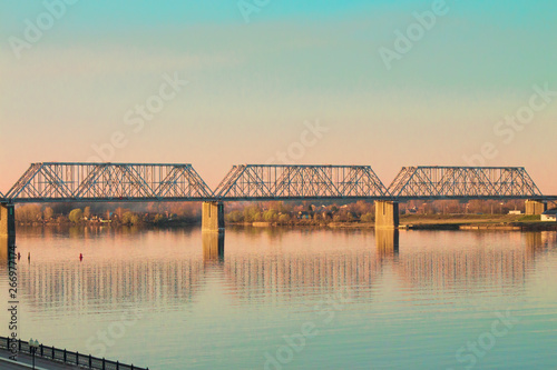 eliable large long bridge across a wide river, spring time