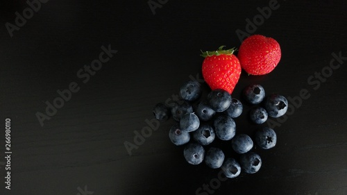 Blueberries and Strawberries on Black Background
