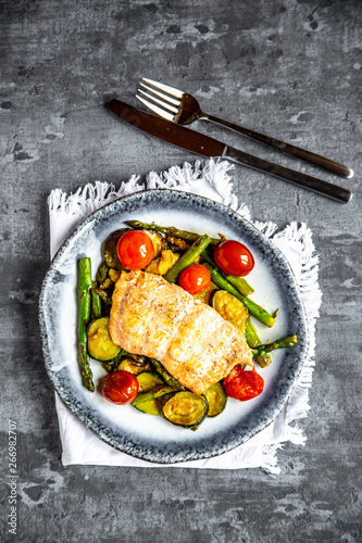 Coalfish fillet on zucchini, green asparagus and tomato, low carb