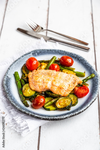 Coalfish fillet on zucchini, green asparagus and tomato, low carb