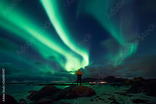 Norway, Lofoten Islands, Eggum, man admiring northern lights