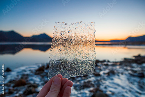 Norway, Lofoten Islands, man's hand holding thin ice