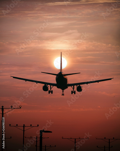 Airplane Touching Down at Sunset