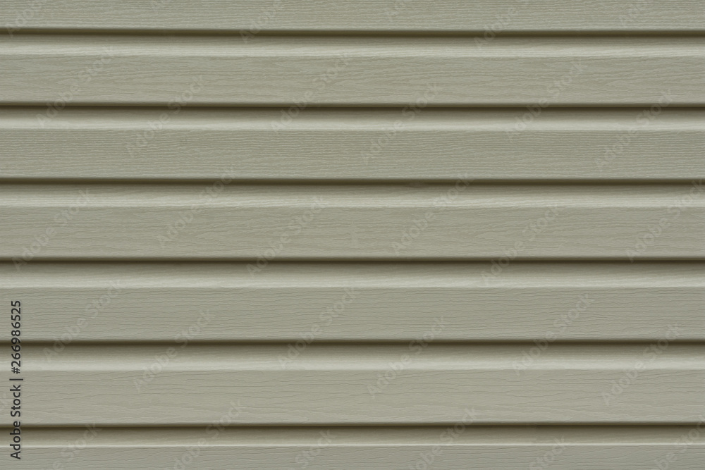 Obraz premium Element of the facade. Part of the facade decoration close-up. Facing material of buildings. Metal sheet roof. Horizontal sheet. Grey.
