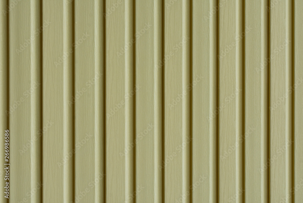 Obraz premium Element of the facade. Part of the facade decoration close-up. Facing material of buildings. Metal sheet roof. Vertical sheet. Brown.