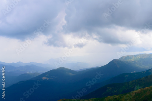 Panoramic view on thunderstorm clouds from Hoverla, Carpathian mountains, Ukraine. Horizontal outdoors shot