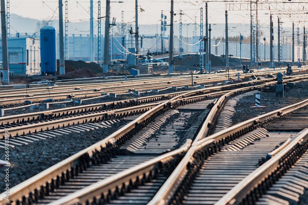 Fototapeta premium View of the rails, concrete sleepers and mound of crushed stone. The railroad tracks.