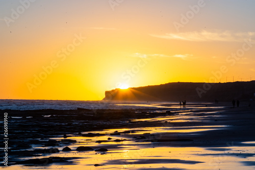 Sunset overlooking the beach and sea cliff  very warm tonality.