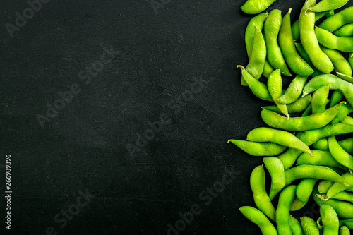 Green soybeans background on black desk top view mockup
