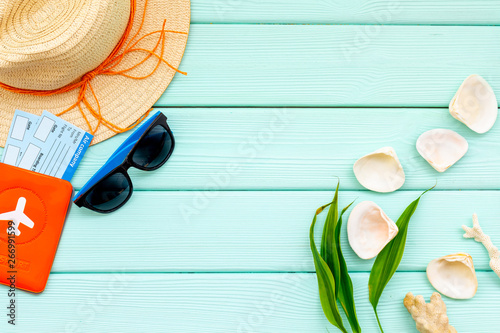 Summer travaling to the sea with straw hat, sun glasses, tickets and passport on mint green background top view mock up photo