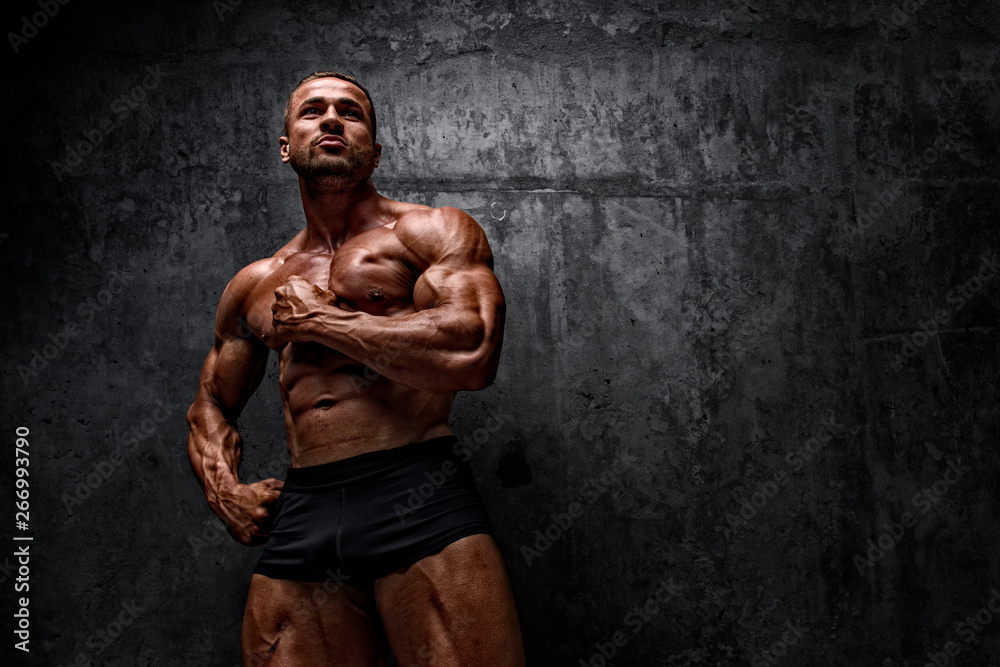 Fototapeta premium Power! Strong Muscular Men posing and Flexing Muscles