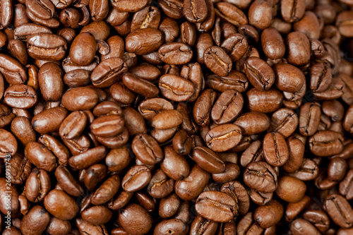 Freshly ground coffee beans roasted with the fruits of the coffee plant, full of grains.