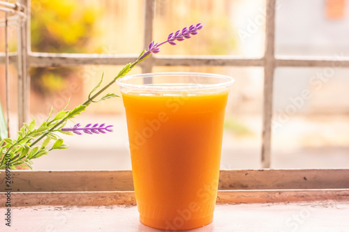 glass of orange juice on background of blue sky