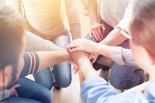 Фотография Close-up view of group of people stacking hands