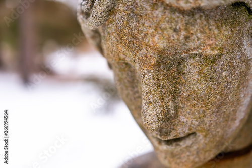 Close up of a stone statue in the winter.