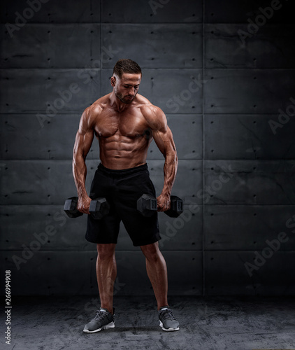 Young Muscular Men Exercise With Dumbbells