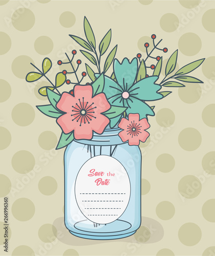 mason jar with floral decorations and save date card