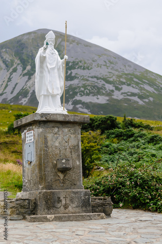 Statue of Saint Patrick at the foot of Croagh Patrick mountain photo