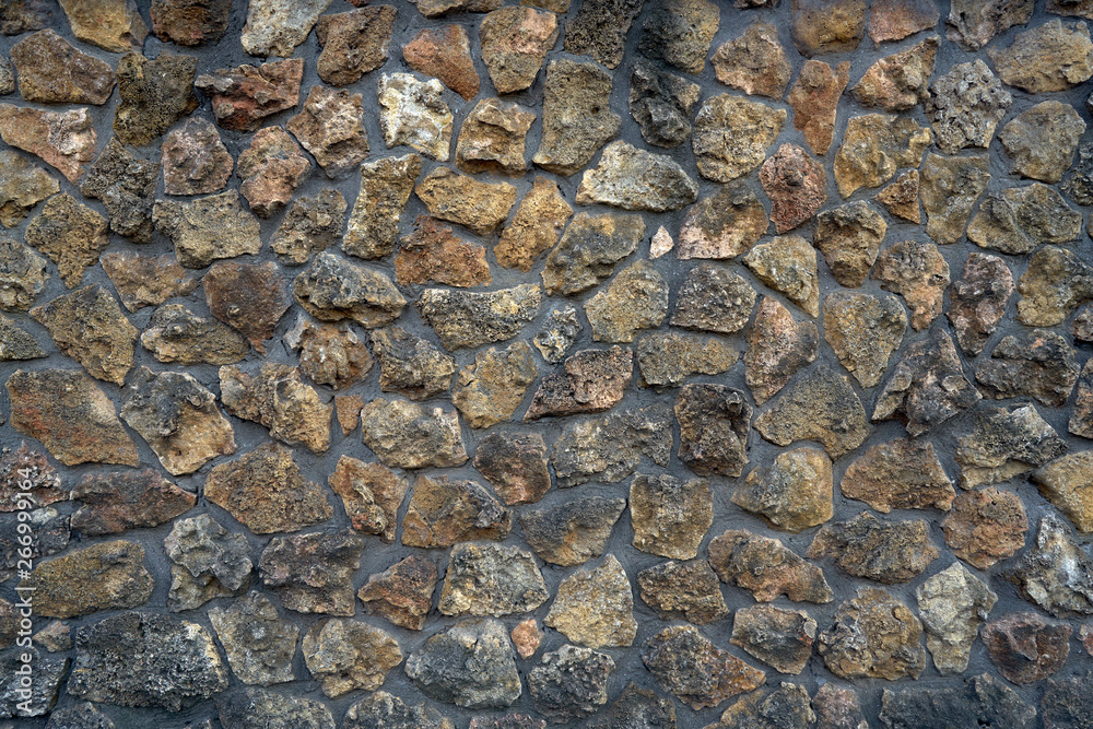 Close-up surface of the old dirty fence made of natural stone and cement Close-up surface of the old dirty fence made of natural stone and cement