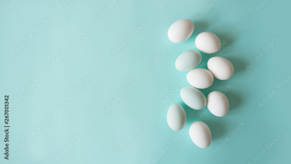 chicken eggs on a blue background bed monochrome shades, place for text, minimalism chicken eggs on a blue background bed monochrome shades, place for text, minimalism