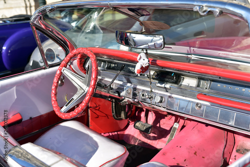 Interior of a red vintage car and view through the windshield, Havana, Cuba