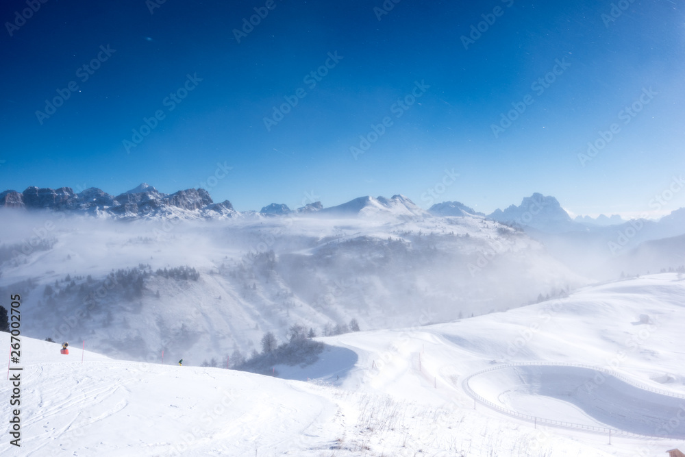 View of mountains through clouds in Alta Badia, Italy