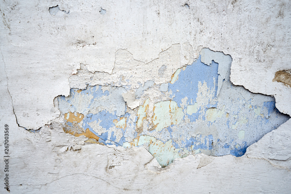 Close-up of old wall with peeling paint surface. Grunge background.
