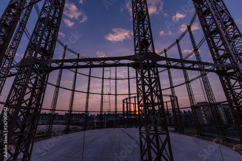 Silhouette of empty gas storage cylinders against the dusk sunset sky in London.