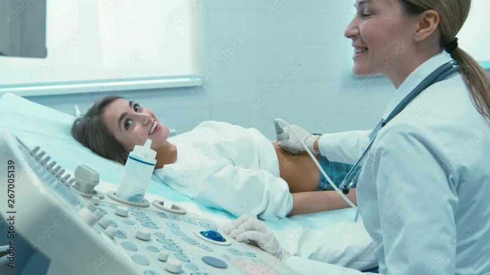Female doctor checking up patient's early pregnancy with ultrasound scanner. Female doctor checking up patient's early pregnancy with ultrasound scanner.