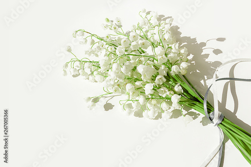 A bouquet of lilies of the valley on a white background. Isolated, selective focus, copy space. photo