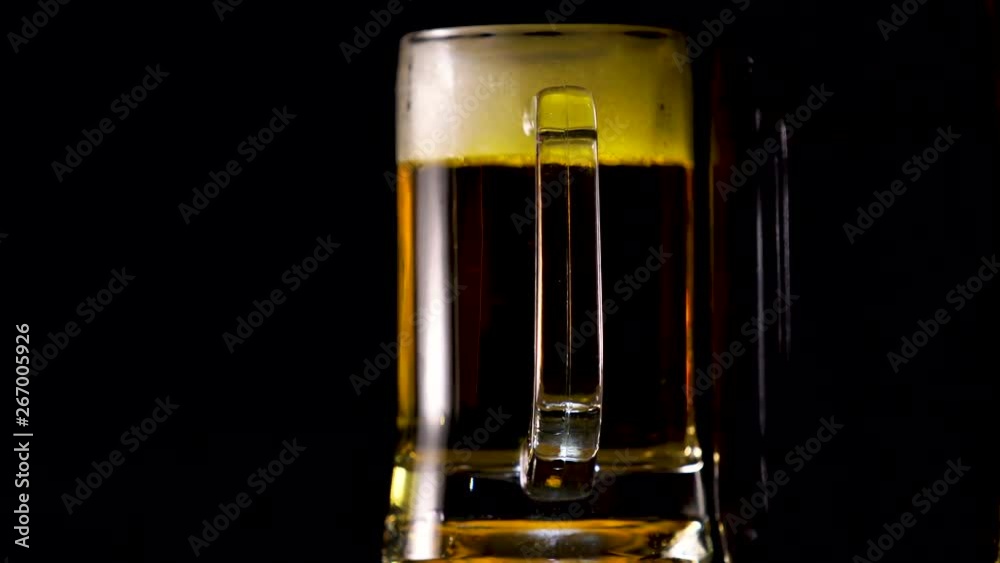Beer in glass on the table on a dark background Beer in glass on the table on a dark background