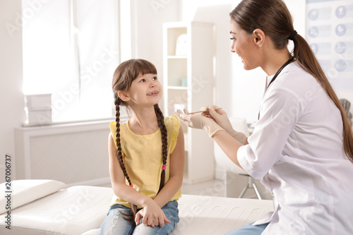 Wallpaper Mural Doctor examining adorable child in hospital office Torontodigital.ca