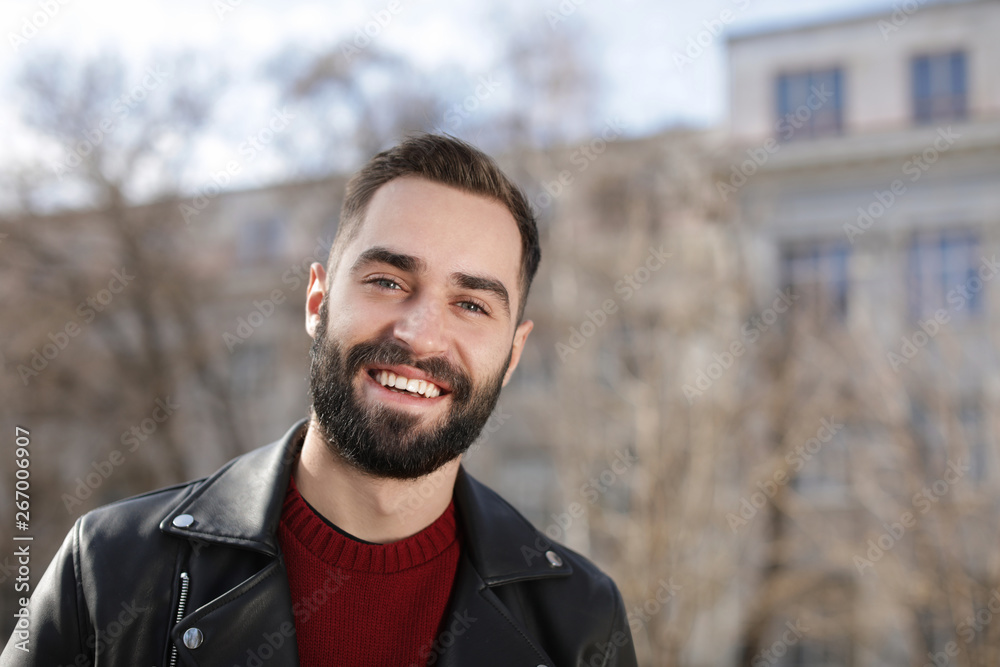 Portrait of happy young man outdoors on sunny day Portrait of happy young man outdoors on sunny day