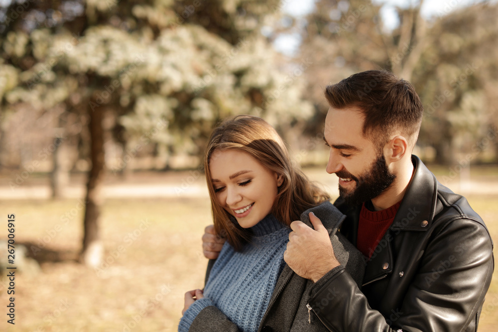 Portrait of cute young couple in park on sunny day Portrait of cute young couple in park on sunny day