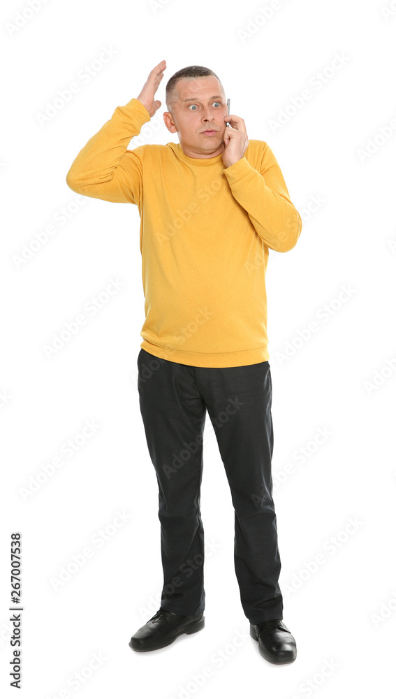 Full length portrait of emotional mature man talking on phone against white background Full length portrait of emotional mature man talking on phone against white background