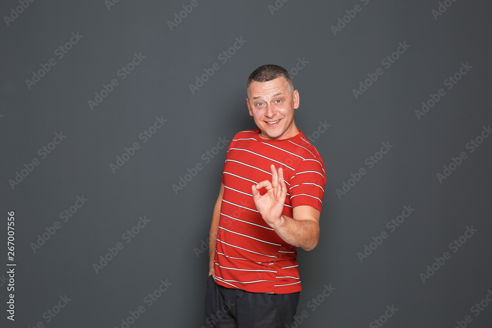 Portrait of happy mature man on dark background Portrait of happy mature man on dark background