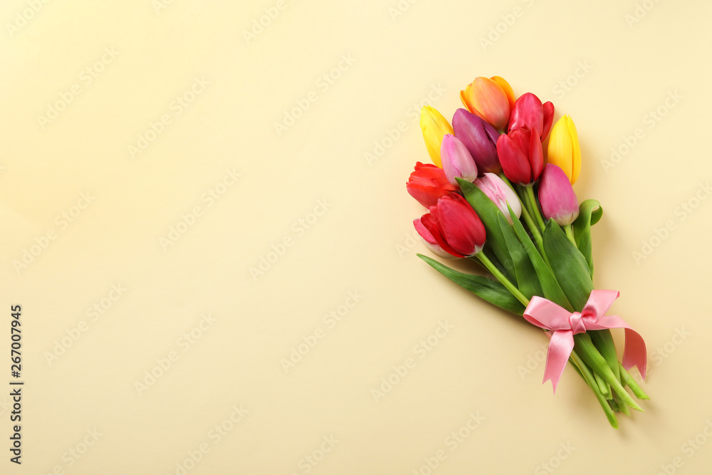 Beautiful bouquet of spring tulip flowers on color background, top view. Space for text Beautiful bouquet of spring tulip flowers on color background, top view. Space for text