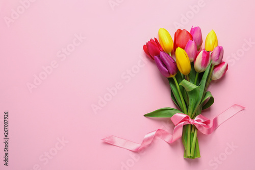 Fototapeta Naklejka Na Ścianę i Meble -  Beautiful bouquet of spring tulip flowers on color background, top view. Space for text