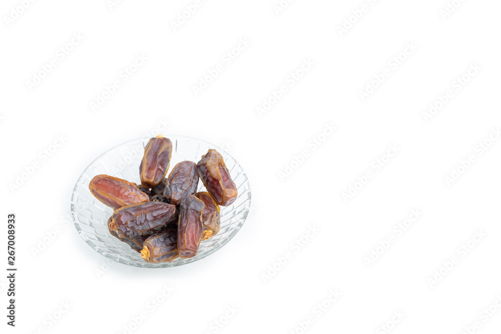 Close up, dates on glass tray isolated on white background, selective focus, Islam religion fasting on ramadan mubarak celebration concept. Close up, dates on glass tray isolated on white background, selective focus, Islam religion fasting on ramadan mubarak celebration concept.