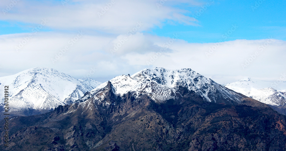 Panorama of snowy mountains and blue sky