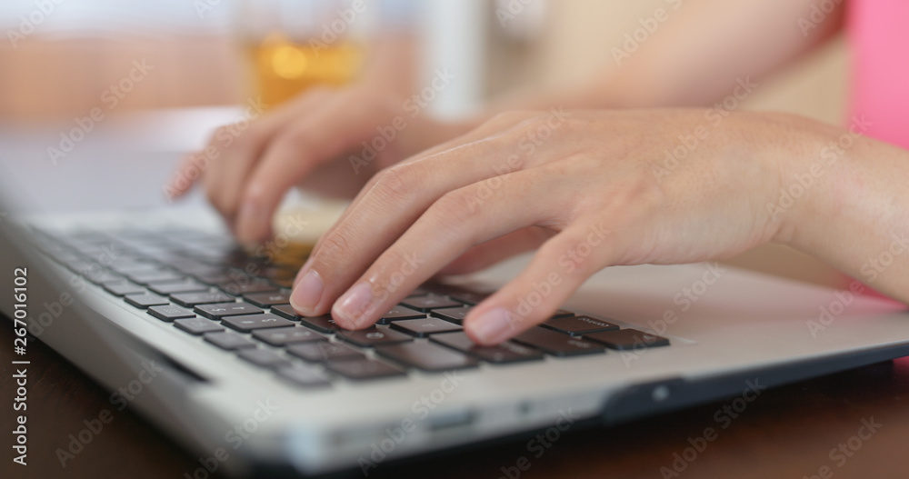 Woman uses tablet on table at home Woman uses tablet on table at home