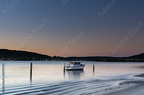 Soft Clear Skies Dawn Waterscape with Boat © Merrillie