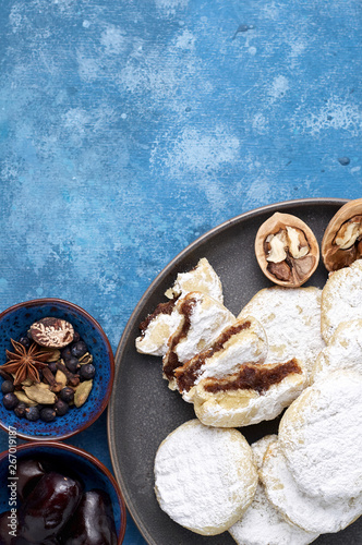 Arabic homemade cookies filled with dates and walnuts covered powdered sugar photo