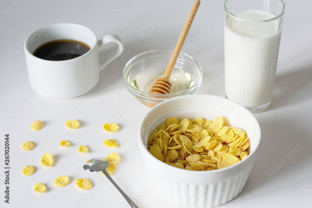 Healthy breakfast with cornflakes and milk over white background Healthy breakfast with cornflakes and milk over white background