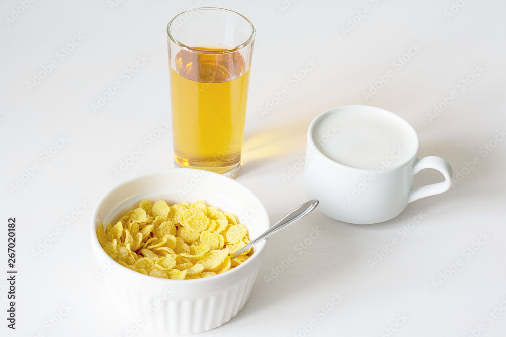 Healthy breakfast with cornflakes and milk over white background Healthy breakfast with cornflakes and milk over white background