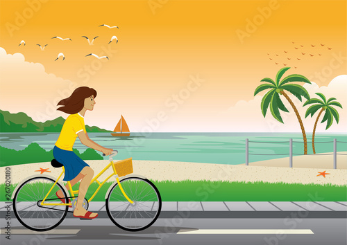 girl riding bicycle at the beach