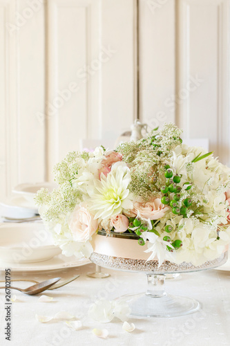 Floral decorations on summer party table   romantic wedding reception.