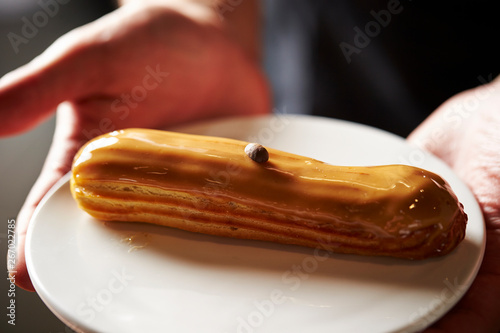 Coffee flavor eclair on plate 